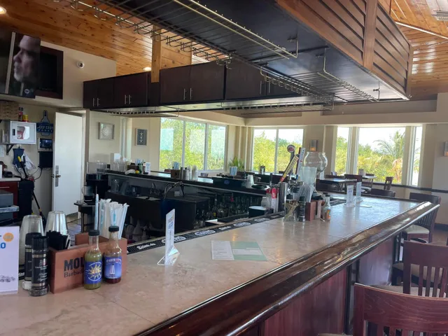 a kitchen with a sink counter top space and living room