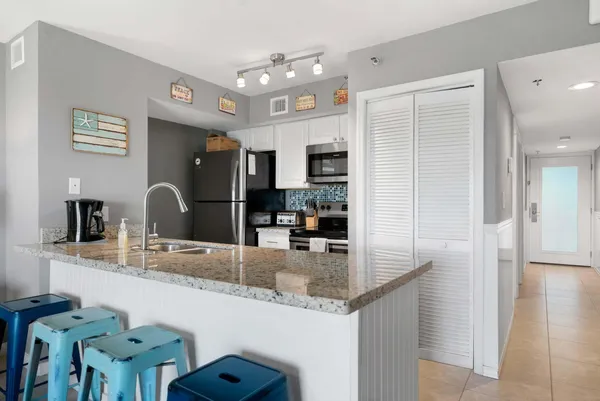 a kitchen with granite countertop a sink and cabinets