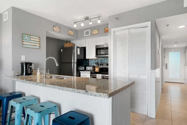 a kitchen with granite countertop a sink and cabinets