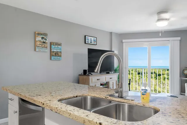 a kitchen with a sink and a stove top oven