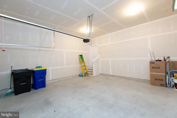 a living room with stainless steel appliances kitchen island granite countertop a refrigerator and a stove top oven
