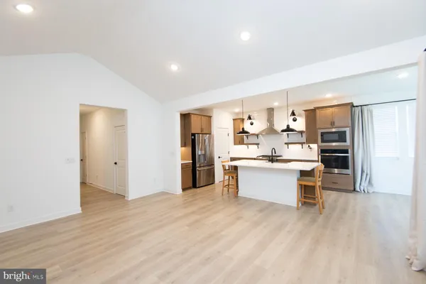 a kitchen with a table a sink and cabinets