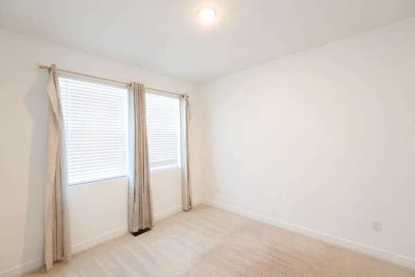 a view of an empty room and a window