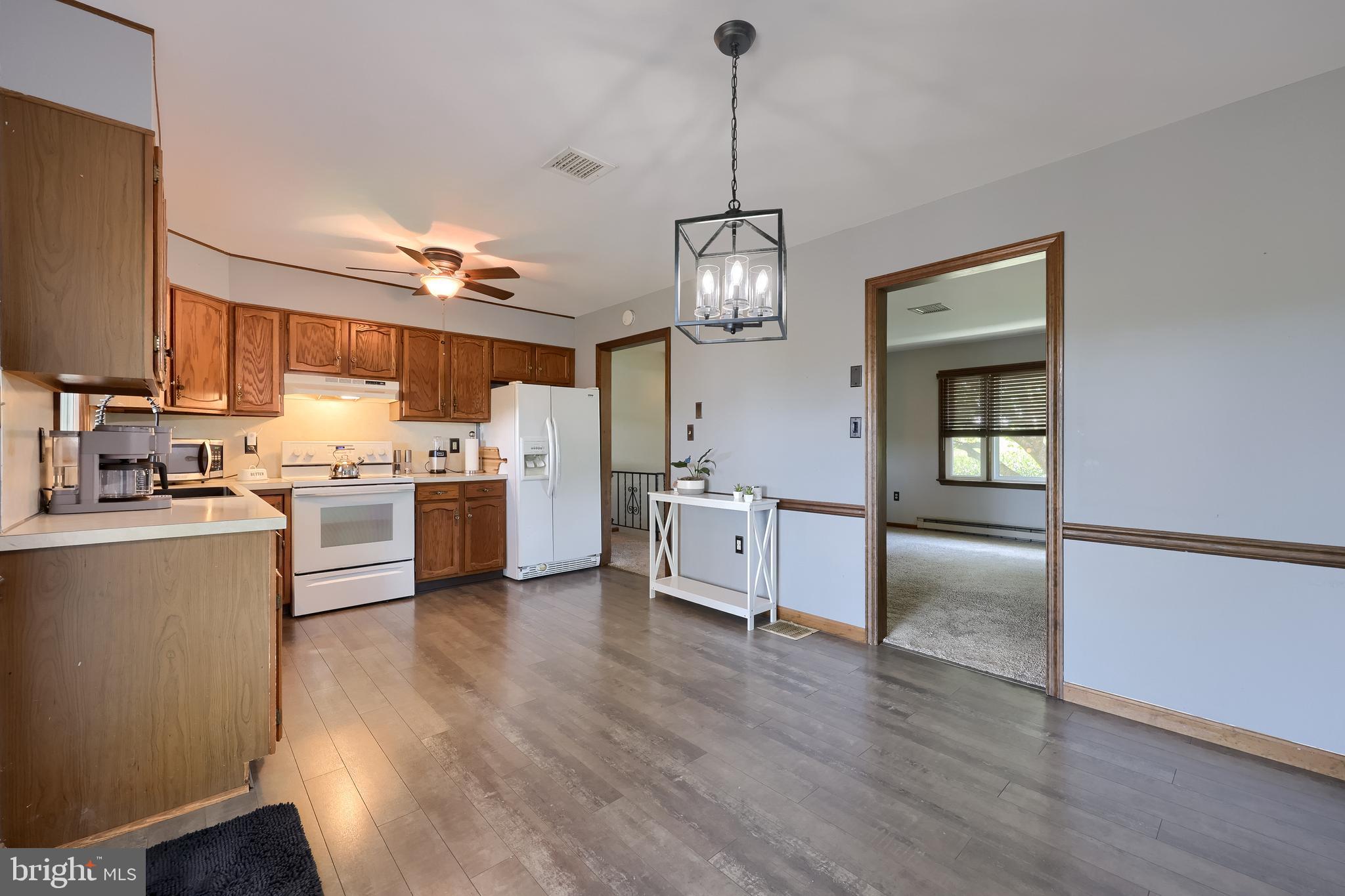 127 West Lexington Road Lititz, PA 17543 - Photo 18 of 48 a kitchen with stainless steel appliances granite countertop a refrigerator a sink dishwasher a stove and white cabinets with wooden floor