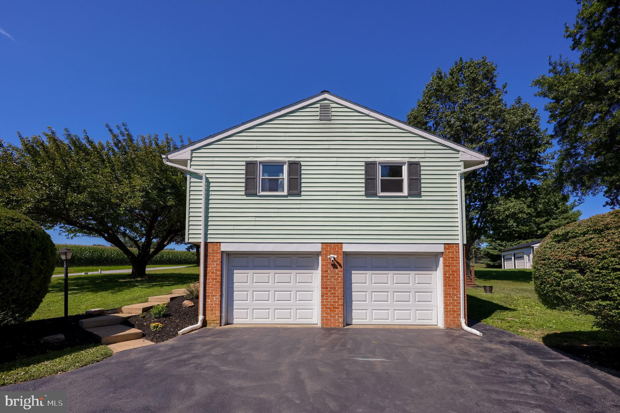 127 West Lexington Road Lititz, PA 17543 - Photo 3 of 48 a front view of a house with a yard and garage
