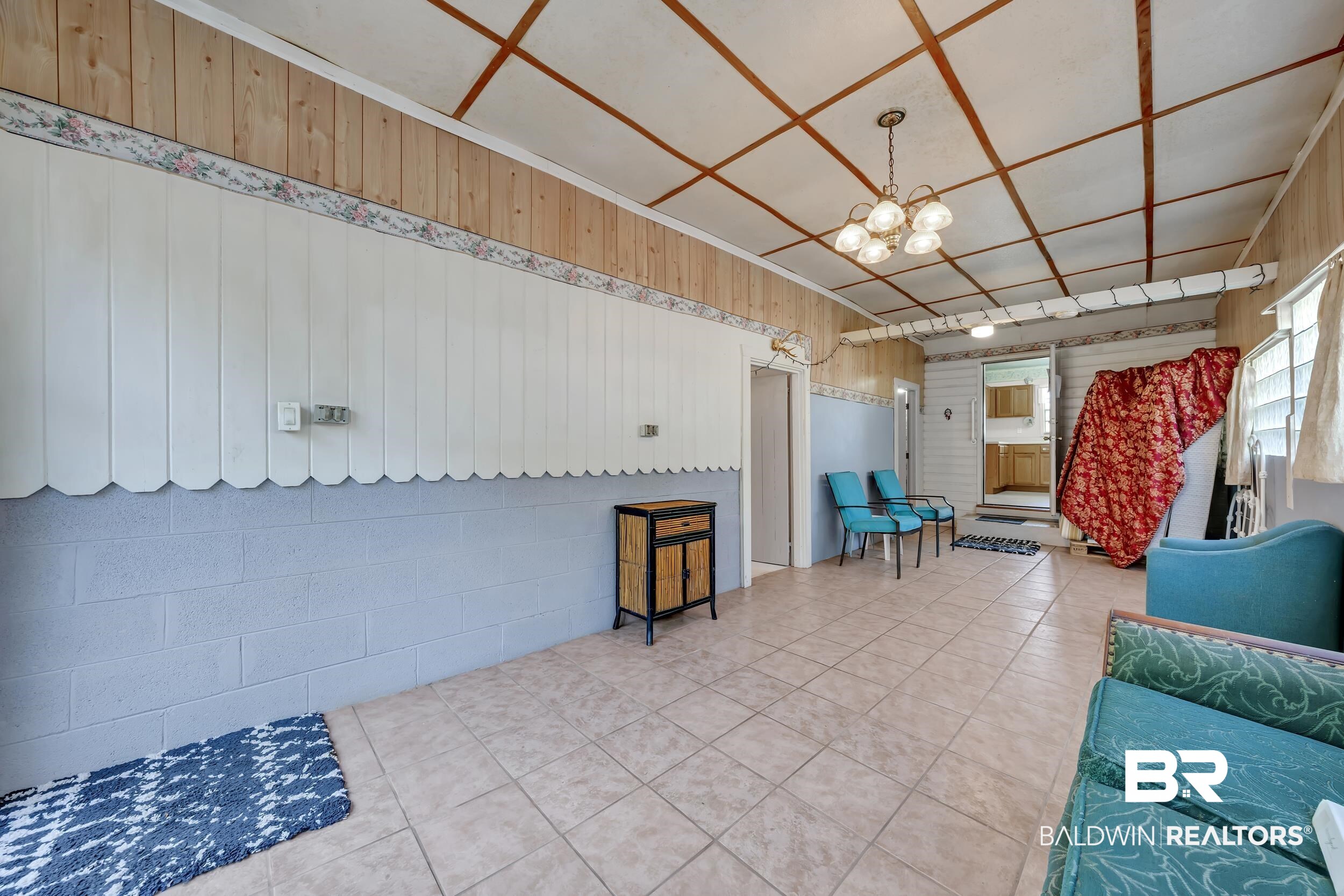 304 West Myrtle Avenue Foley, AL 36535 - Photo 18 of 29 Spacious room featuring tile flooring, exposed wood plank ceiling, and wood-finish paneling