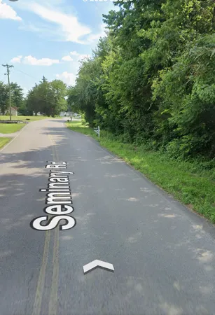 a view of a street with a yard