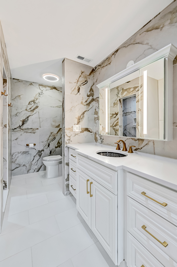 3220 Meyers Road Oak Brook, IL 60523 - Photo 34 of 43 a spacious bathroom with double vanity sink and a mirror