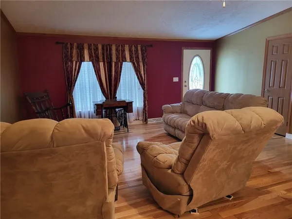 a living room with furniture a window and a chandelier