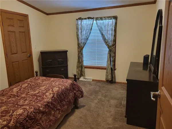 a bedroom with a bed and a dresser