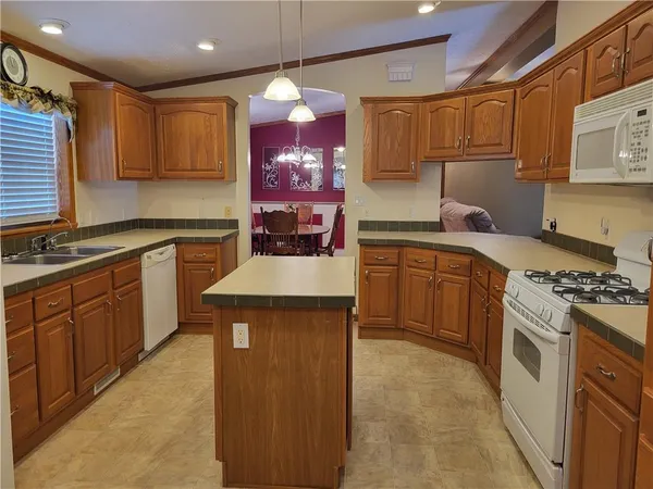 a kitchen with a sink stove and cabinets