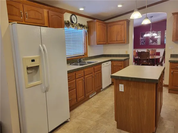 a kitchen with cabinets and chairs