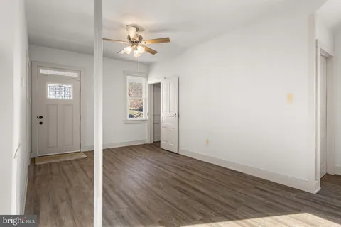 a view of an empty room with wooden floor