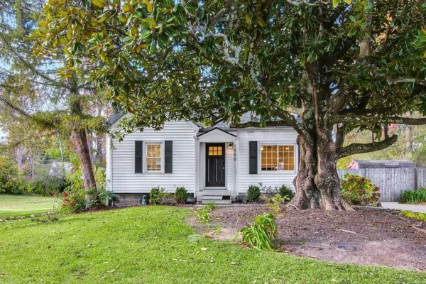 a front view of house with yard and green space