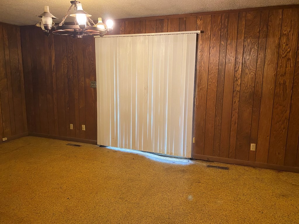 8693 Eureka Road Northwest Charleston, TN 37310 - Photo 11 of 35 an empty room with a chandelier fan