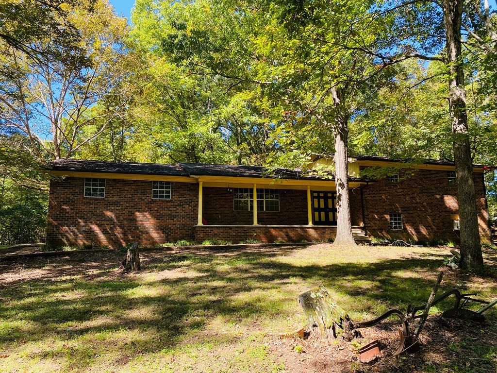 8693 Eureka Road Northwest Charleston, TN 37310 - Photo 2 of 35 a view of a backyard with table and chairs under an umbrella