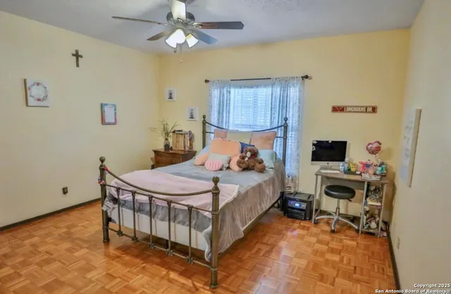 a bedroom with a bed and a desk