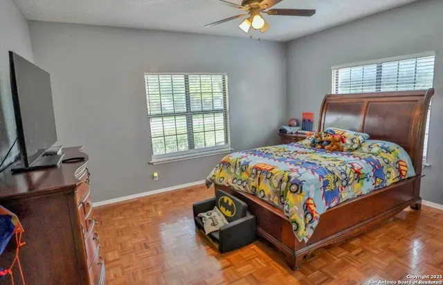 a bedroom with a bed and a chandelier