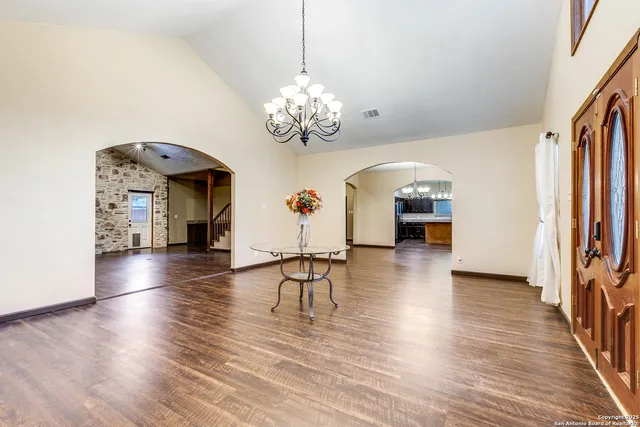 a view of a livingroom with furniture wooden floor chandelier