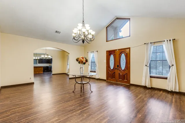 a view of a room with wooden floor and window