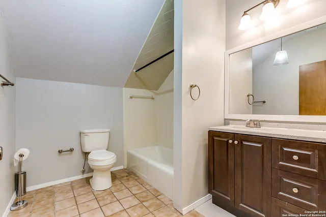 a spacious bathroom with a sink toilet and shower