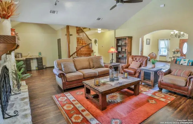 a living room with furniture and a wooden floor