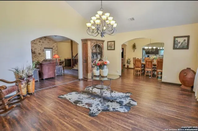 a living room with furniture and a chandelier