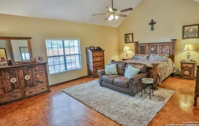 a spacious bedroom with a bed a couch and dresser