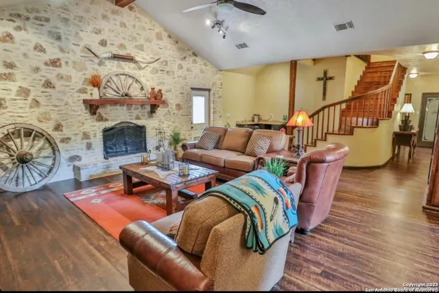 a living room with fireplace furniture and a wooden floor
