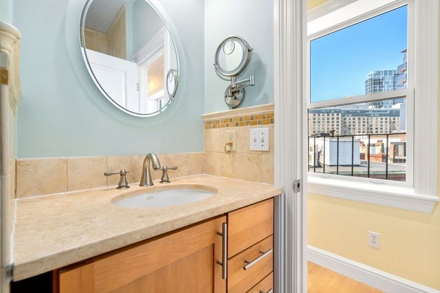 a view of a balcony with wooden floor and fence