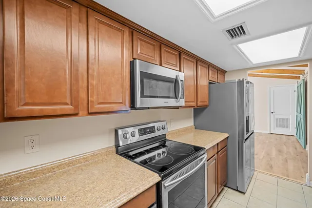 a kitchen with wooden cabinets and a stove top oven