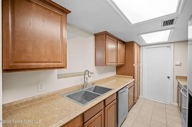 a kitchen with a sink and a refrigerator