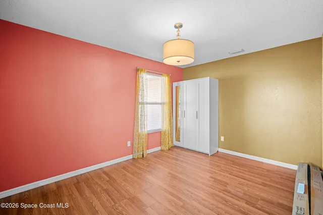 a view of a room with wooden floor and iron gate