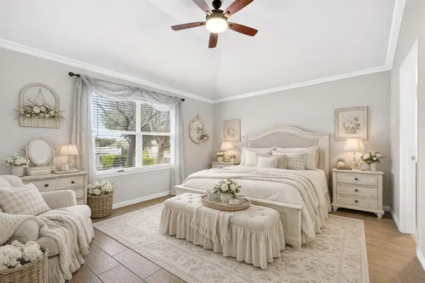 a bedroom with a bed and a large window