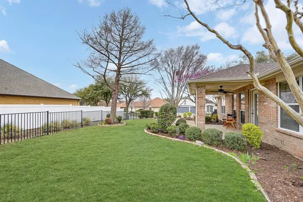 a view of a house with a big yard and a large tree