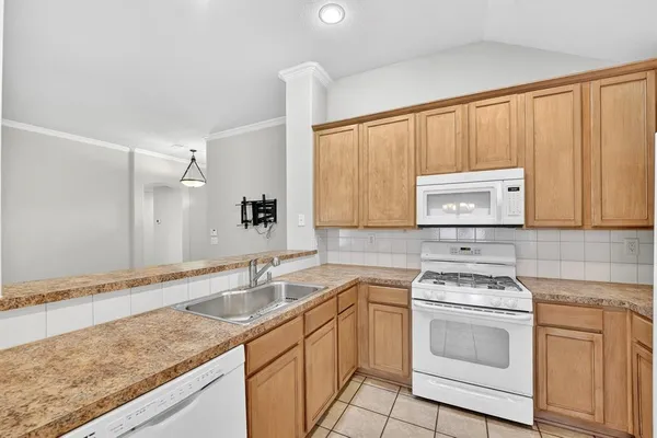 a kitchen with a sink stove and cabinets