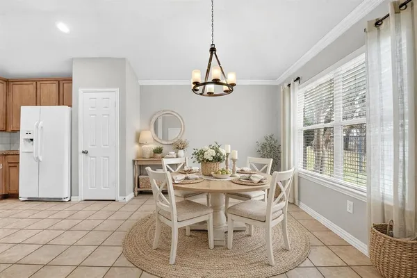 a dining room with furniture a chandelier and window