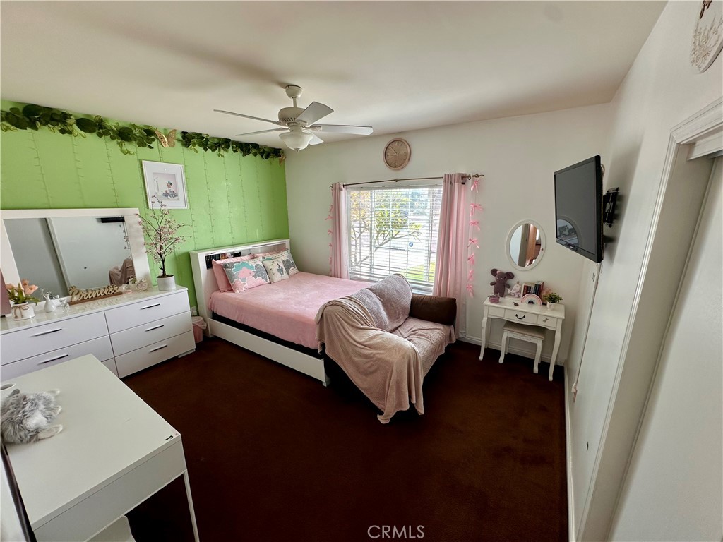 514 West Randall Avenue Rialto, CA 92376 - Photo 11 of 19 a bedroom with a bed wooden floor and window