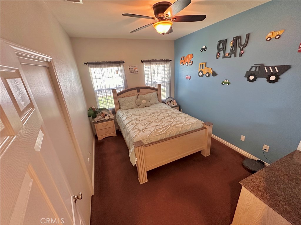 514 West Randall Avenue Rialto, CA 92376 - Photo 13 of 19 a bedroom with a bed and a chandelier