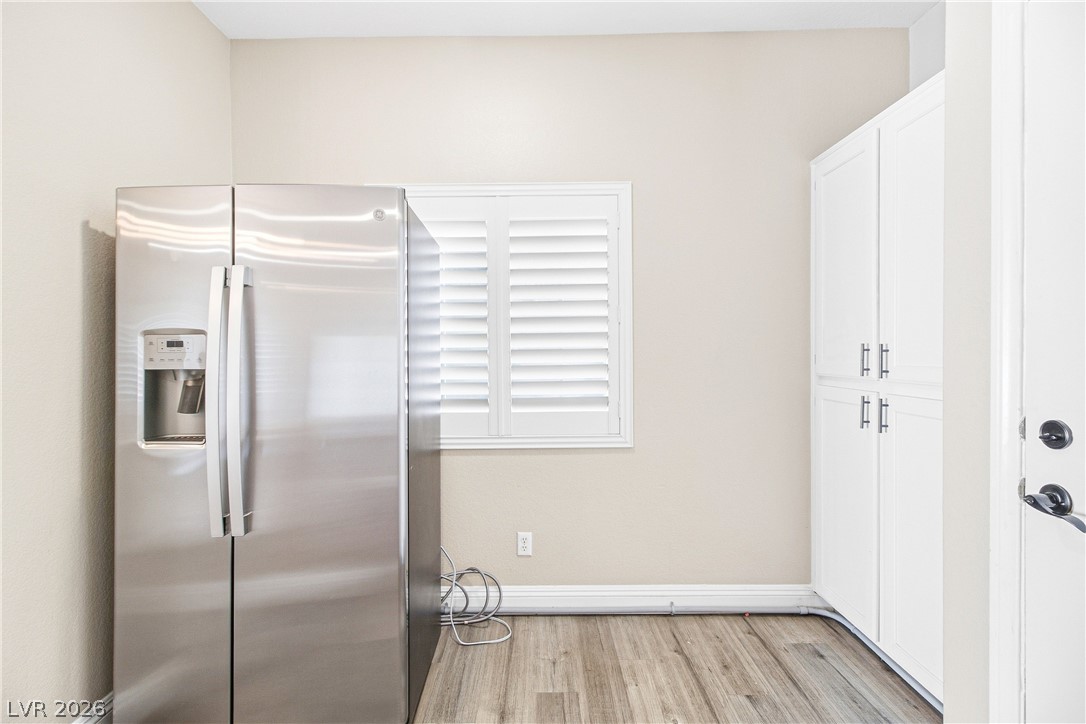 1475 Reef Ridge Court Las Vegas, NV 89128 - Photo 7 of 24 Plentiful built-in cabinetry and durable wood-look flooring enhance this highly functional utility space.