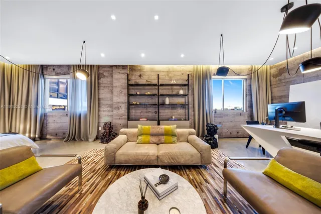 a bedroom with a bed a couch and large window