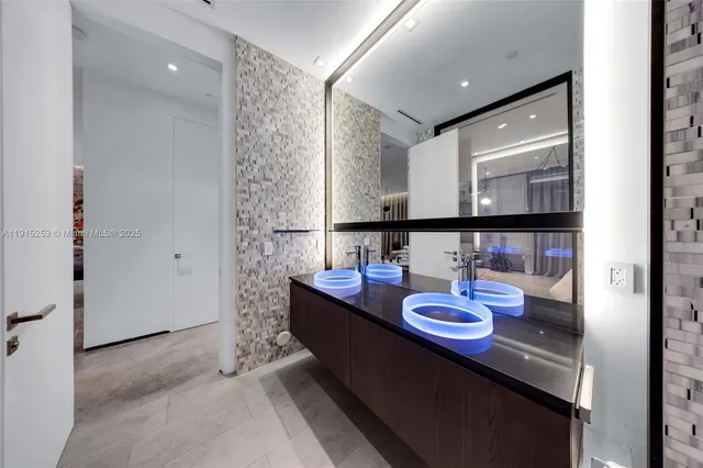 a large white kitchen with a large window