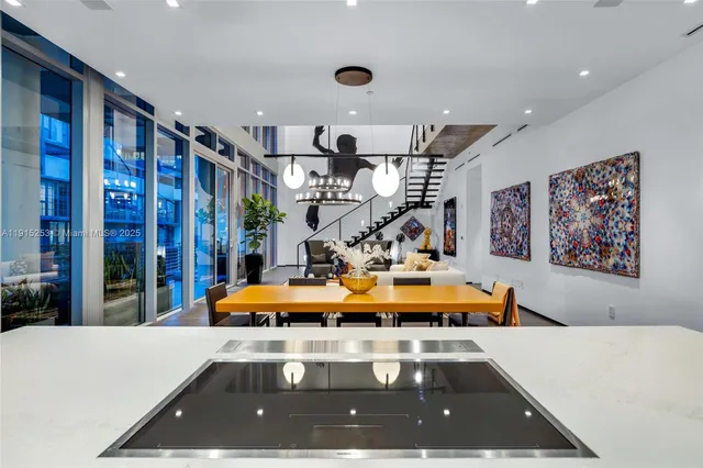 a view of a balcony with chairs and potted plants