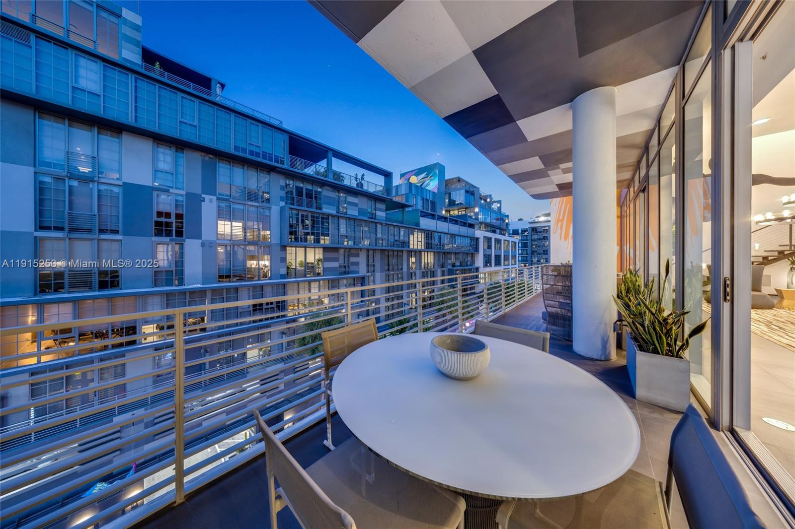 250 Northwest 24th Street, Unit PHA Miami, FL 33127 - Photo 26 of 68 a view of a balcony with chairs and potted plants
