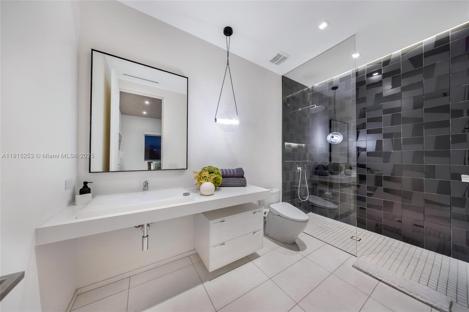 250 Northwest 24th Street, Unit PHA Miami, FL 33127 - Photo 42 of 68 a bathroom with a double vanity sink and a mirror