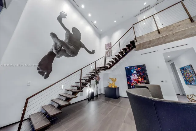 a bedroom with bed and a chandelier