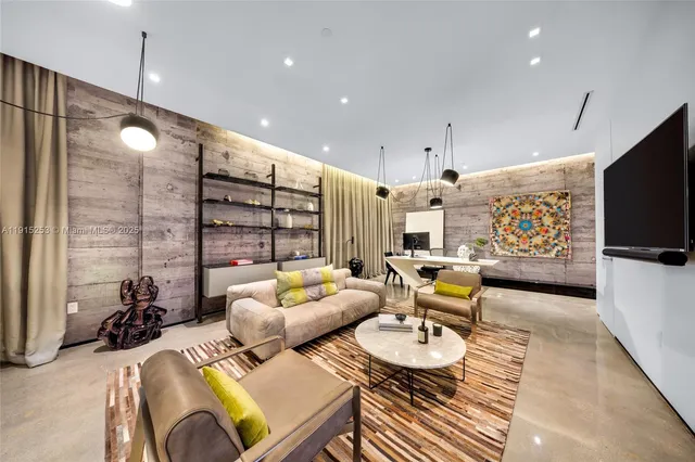 a living room with furniture a rug and a chandelier