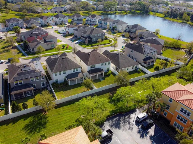 an aerial view of a house with swimming pool and outdoor seating