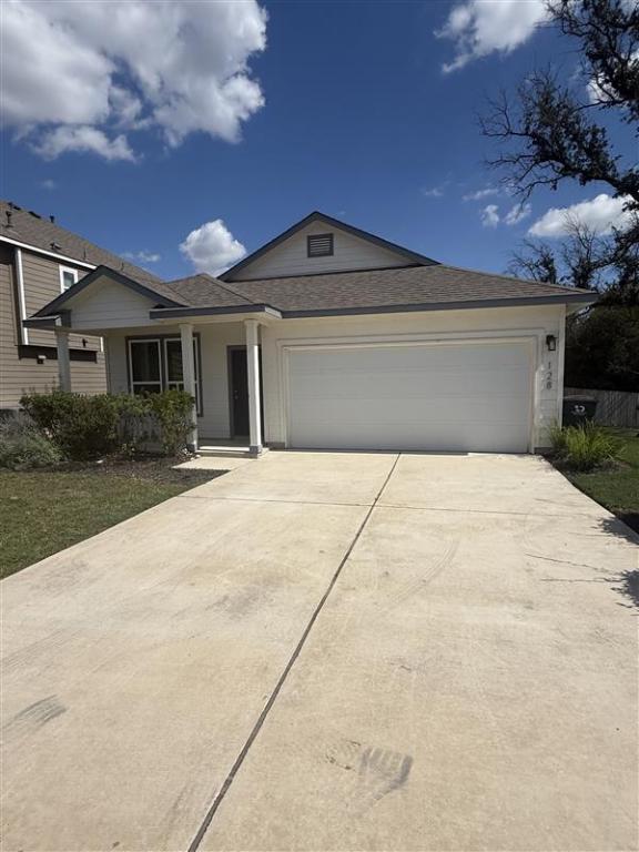a front view of a house with yard and tress