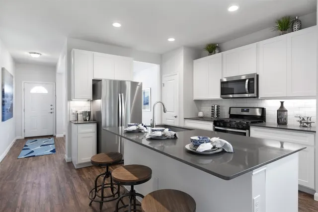 a kitchen with a sink a stove and refrigerator